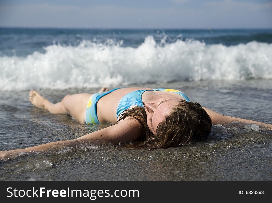Resting woman on sea beach