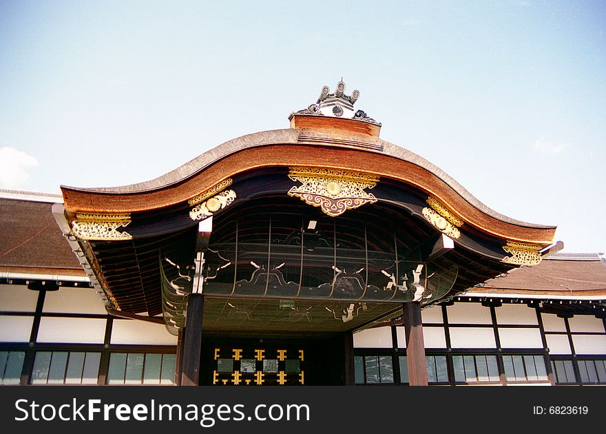 An ornate gate on the grounds of the Kyoto Imperial Palace with curved roof. An ornate gate on the grounds of the Kyoto Imperial Palace with curved roof