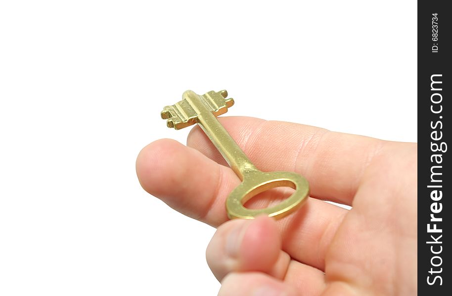 Fingers holding golden keys isolated on white