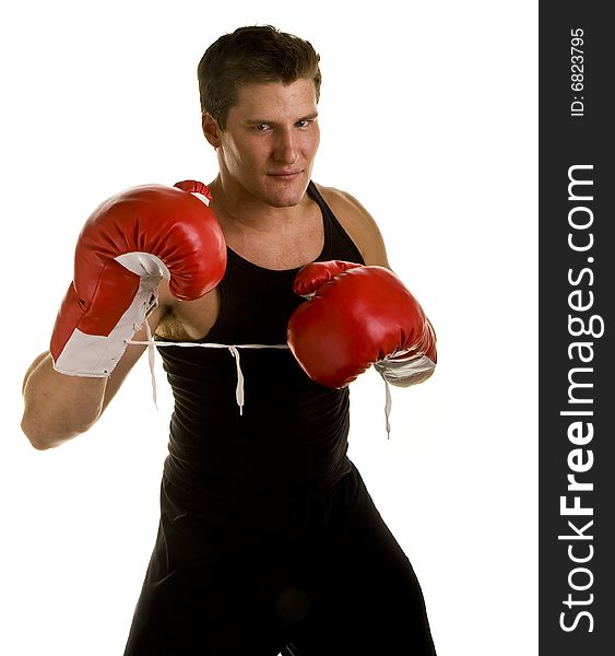 A boxer in workout clothes and red boxing gloves isolated on white. A boxer in workout clothes and red boxing gloves isolated on white
