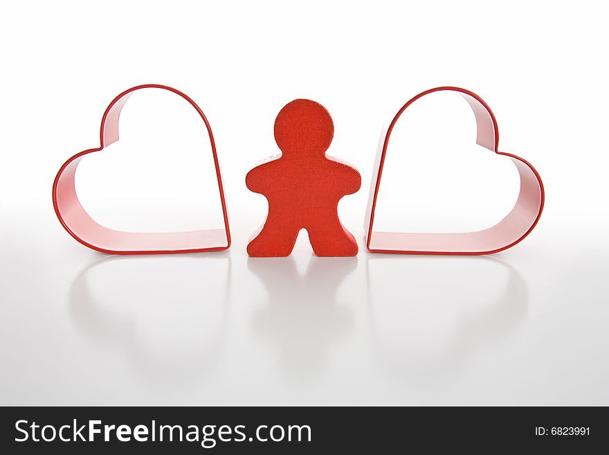 Red wooden person stands between red hearts. Isolated on white background. Red wooden person stands between red hearts. Isolated on white background.