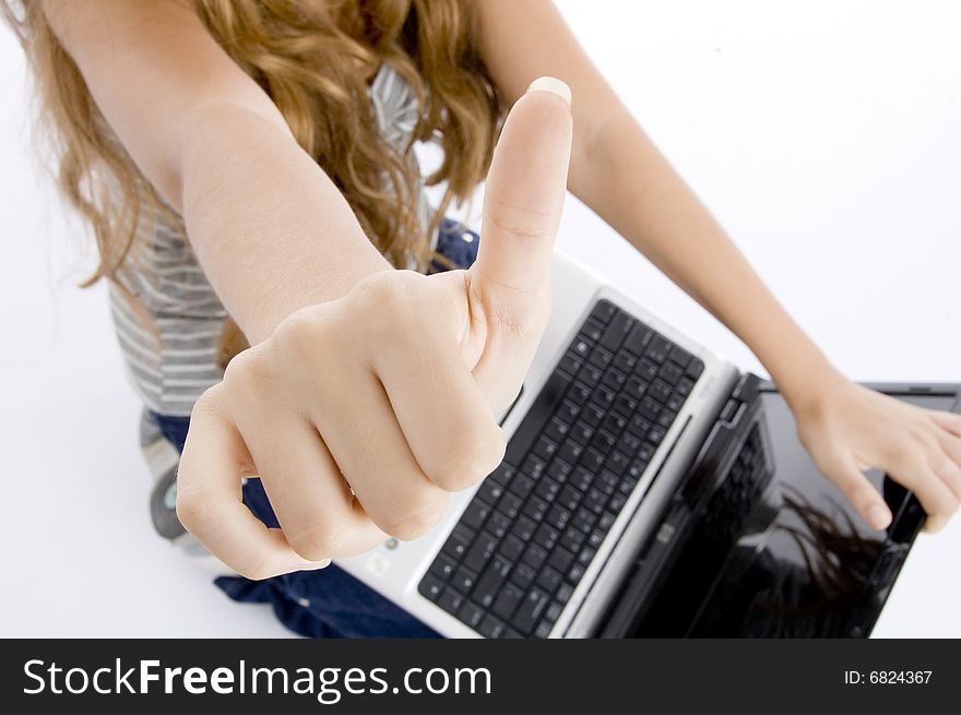 Girl with laptop showing her thumb on  an isolated white background