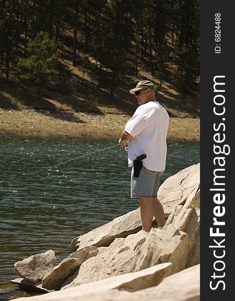 Man Fishing In Rocks