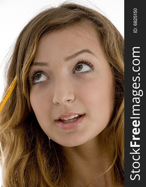 Close up of school girl with a pencil in her hair on  an isolated white background