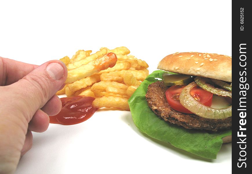 A man eating eating fries and a hamburger. A man eating eating fries and a hamburger