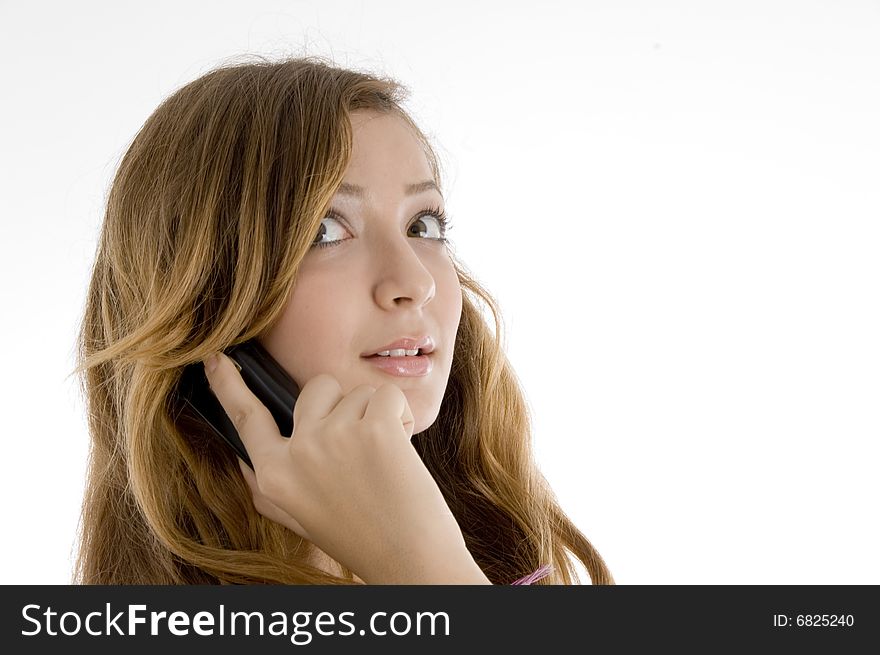 Beautiful female talking on mobile lphne ooking upward on  an isolated white background