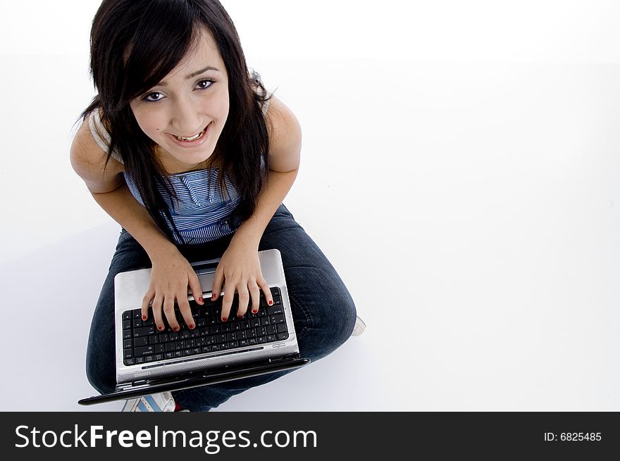 Girl with laptop looking to camera on  an isolated white background