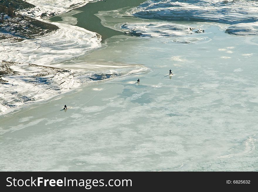 Men fishing on frozen lake. Men fishing on frozen lake