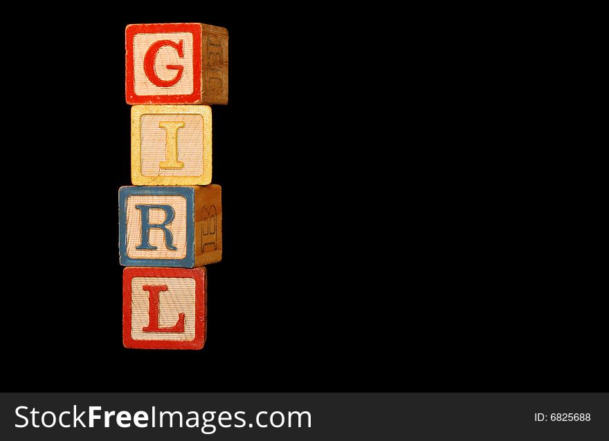 Four wooden baby blocks are stacked up to spell the word Girl with room for copy. Four wooden baby blocks are stacked up to spell the word Girl with room for copy.