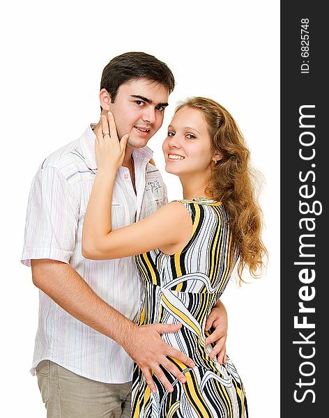 Young smiling and embracing couple on white