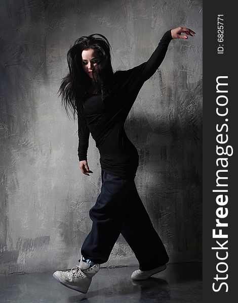 Cool hip-hop style dancer posing. Cool hip-hop style dancer posing