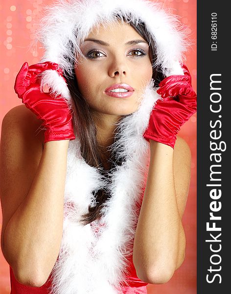 Christmas girl wearing santa claus costume over red background. Christmas girl wearing santa claus costume over red background