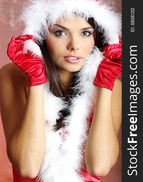 Christmas girl wearing santa claus costume over red background. Christmas girl wearing santa claus costume over red background