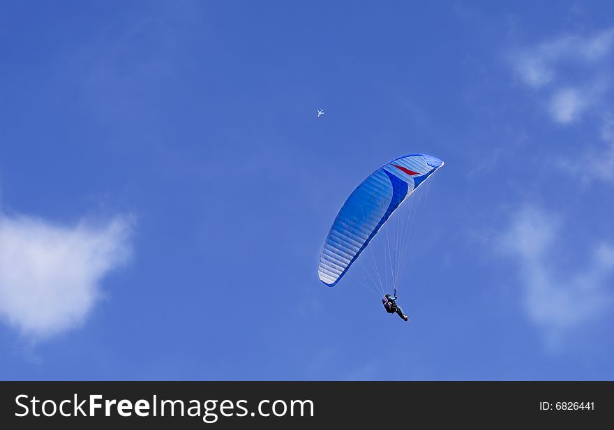 Paragliding and jet in the air
