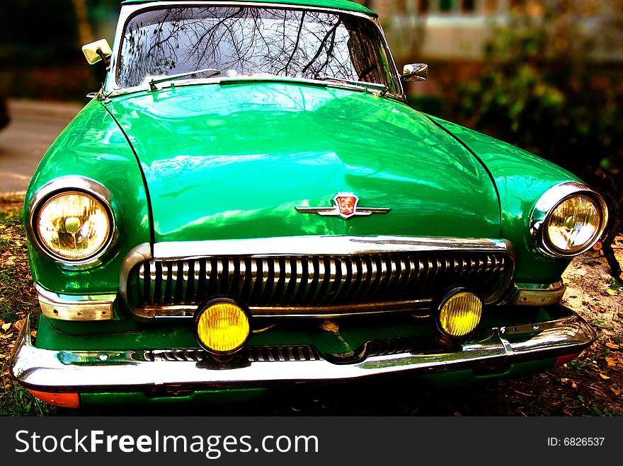 Green old-fashioned car shot with blurred background