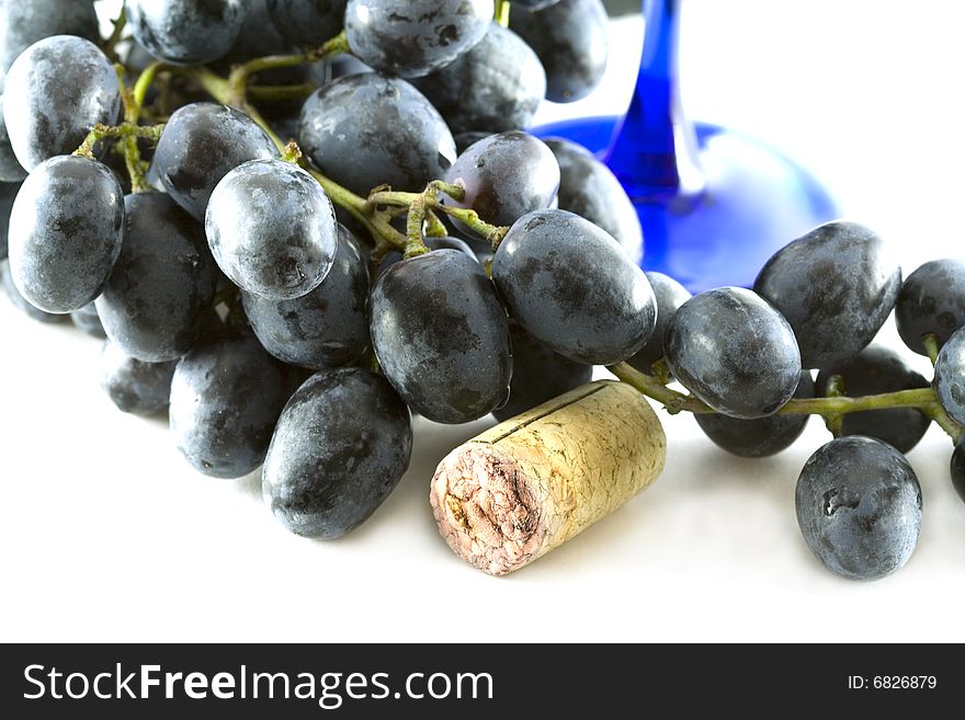 Grape and cork isolated on white