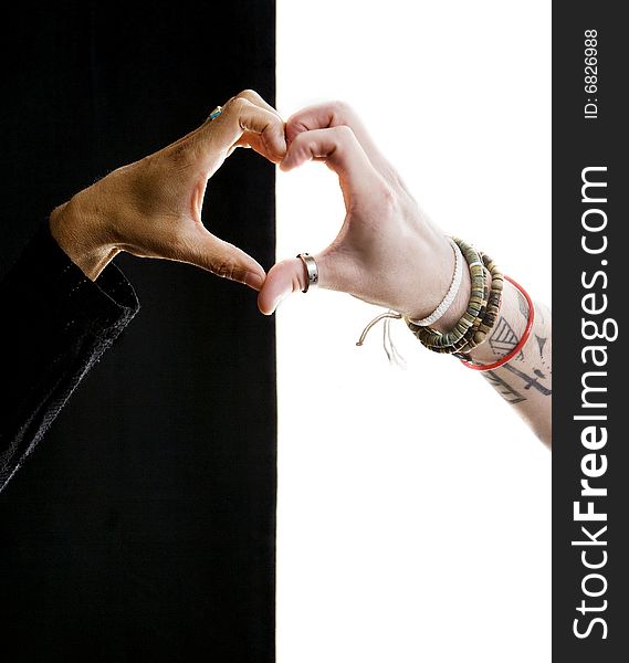 Close up of black and white hands making a heart. Close up of black and white hands making a heart