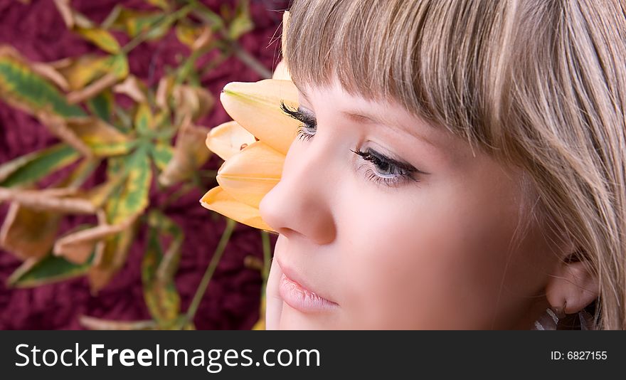 Fashion woman portrait with a beautiful yellow flower