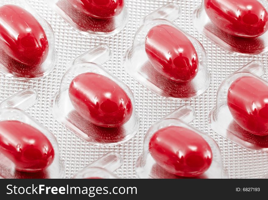 Red oval medical pills in their packages. Red oval medical pills in their packages