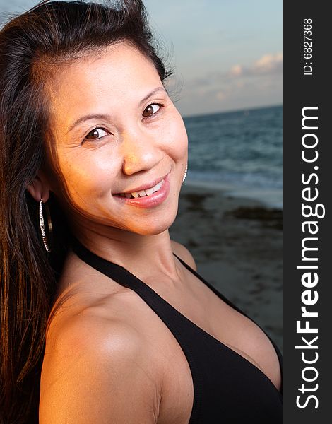 Young female smiling with a beautiful blue sky background. Young female smiling with a beautiful blue sky background