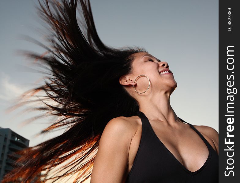 Woman in a bikini flinging her hair in the air. Woman in a bikini flinging her hair in the air.