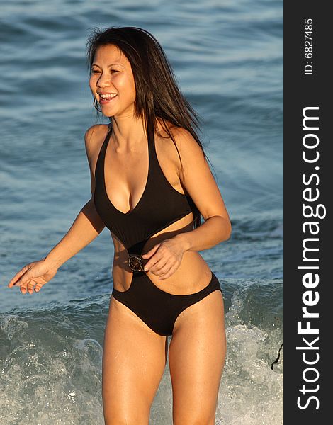Young female in a bikini playing in the ocean. Young female in a bikini playing in the ocean