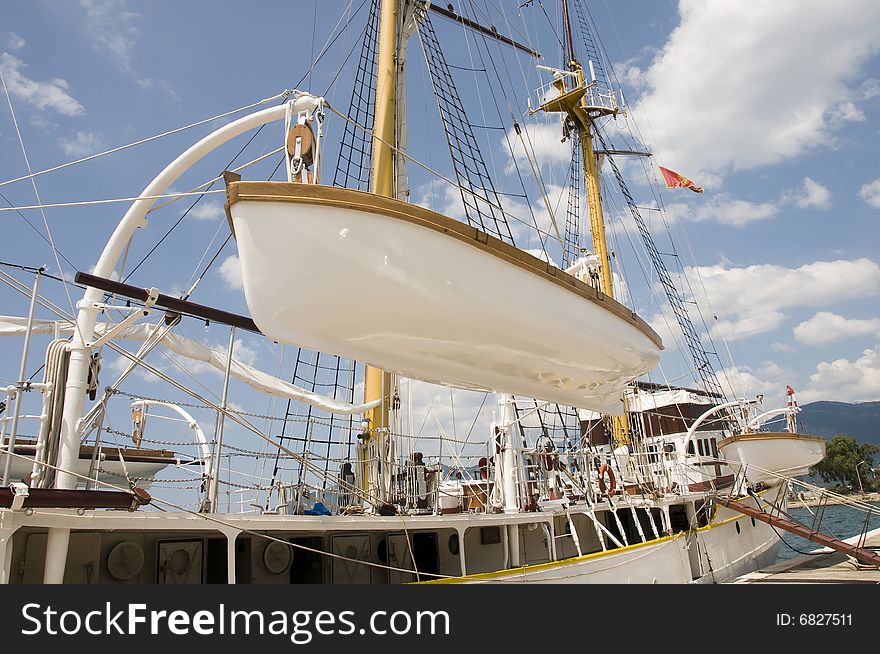 Lifeboat on sailing ship in harbour.