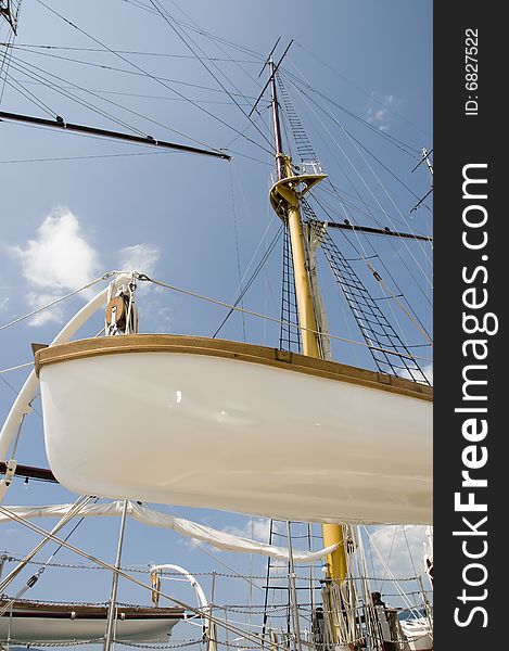 Lifeboat on sailing ship in harbour.