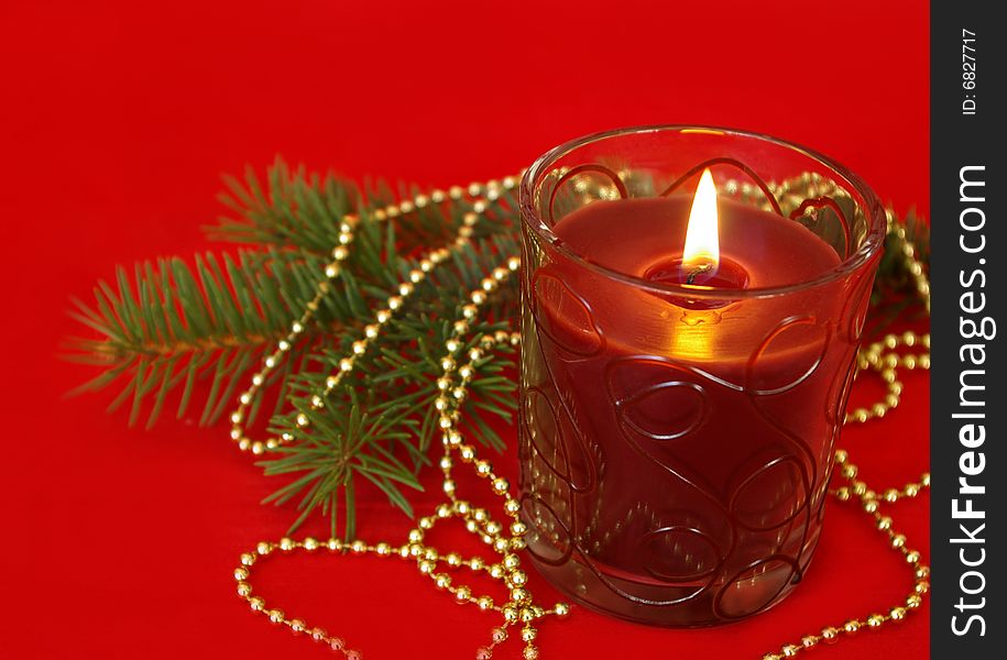 Christmas card. Candle and decoration isolated on red. Christmas card. Candle and decoration isolated on red