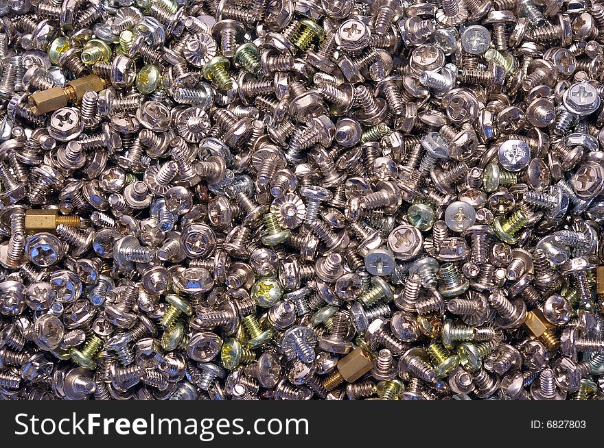 A lot of computer screws as background