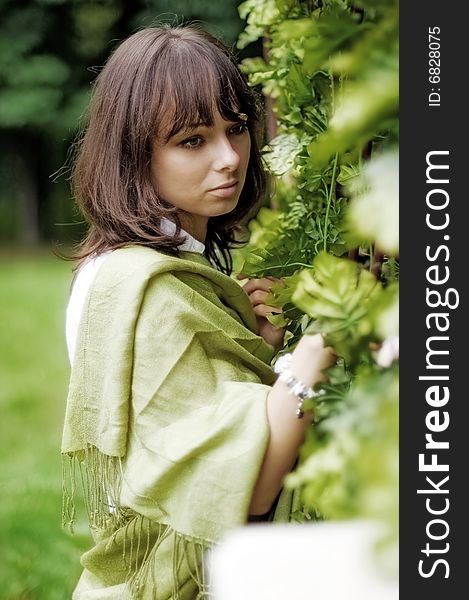 The young woman standing near the wicker fence. The young woman standing near the wicker fence