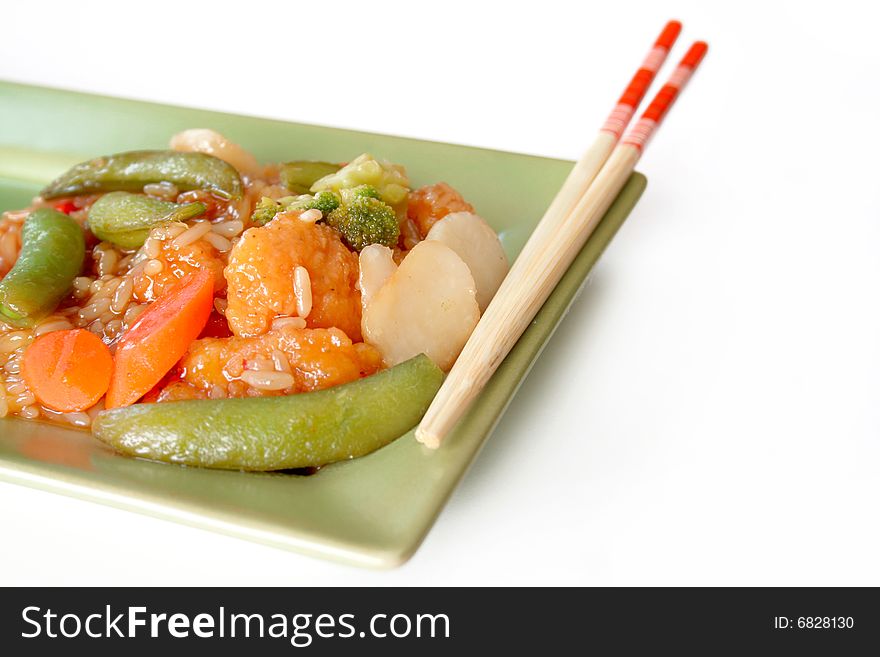 A Chinese plate of chicken and vegetables with rice and chopsticks.  All isolated on white with room for copy space. A Chinese plate of chicken and vegetables with rice and chopsticks.  All isolated on white with room for copy space.