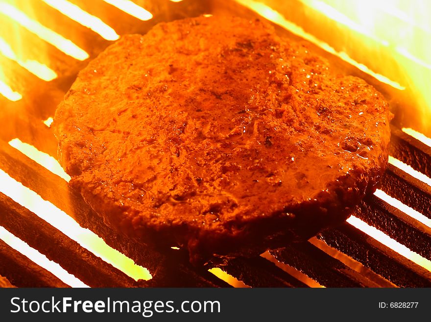 juicy burger on grill with fire. juicy burger on grill with fire