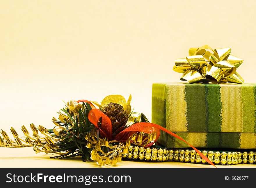 Christmas cone and gift box on yellow background