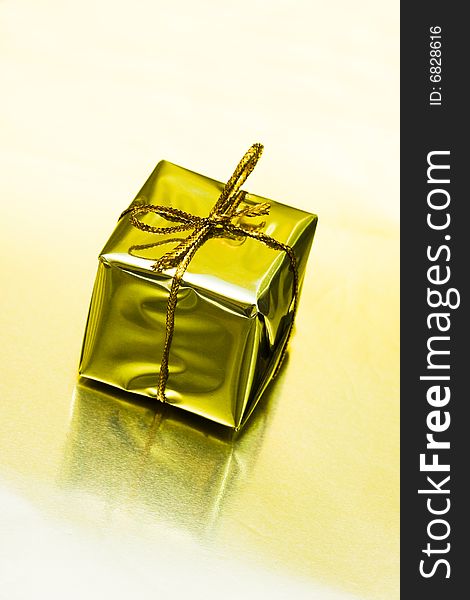 Gift box on golden background