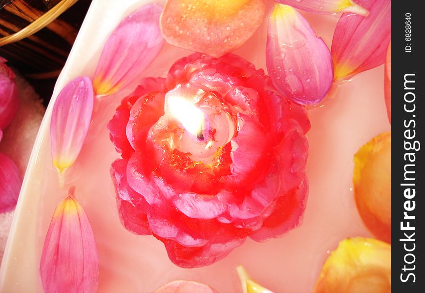 Spa essentials (candle on water and pink flowers)