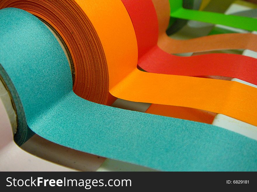 A Rainbow of colored medical/lab tape in a dispenser. A Rainbow of colored medical/lab tape in a dispenser.