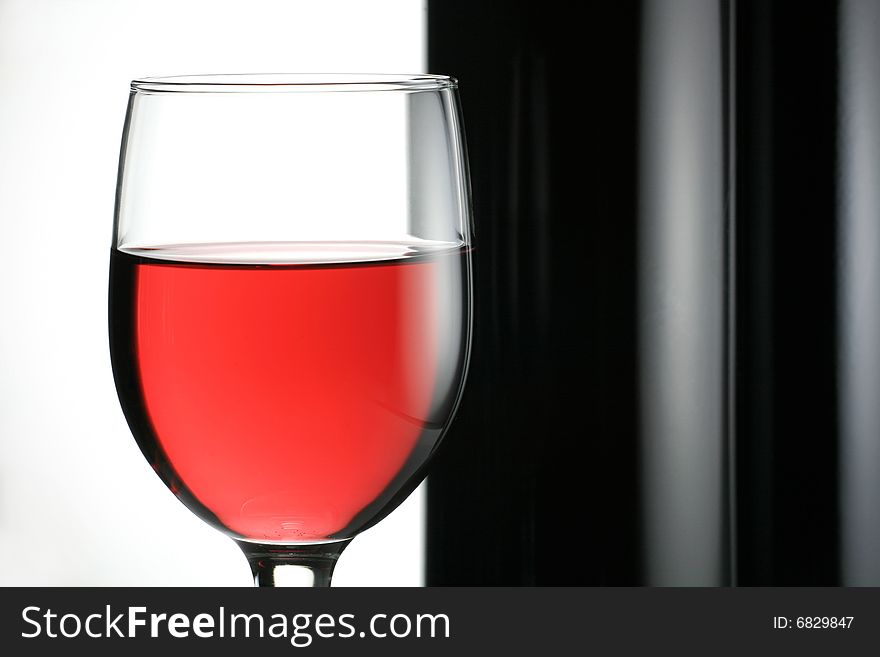 One Glass Red Wine with Two Wine Bottle on White Background. One Glass Red Wine with Two Wine Bottle on White Background