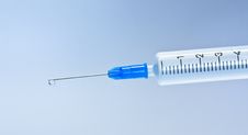 Syringe With Blue Drop Stock Photos