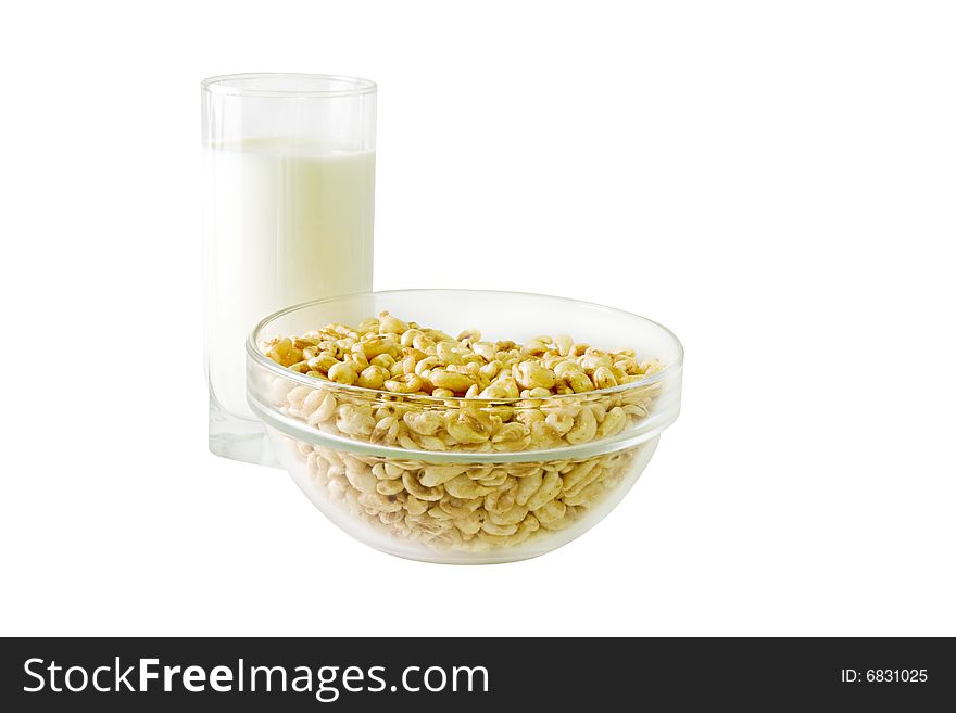 A glass of milk and a bowl of cereals. A glass of milk and a bowl of cereals