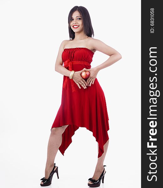 A seductive asian girl of indian origin with a red apple. A seductive asian girl of indian origin with a red apple
