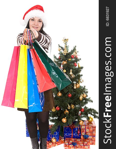 Attractive brunette woman happy over christmas tree. Attractive brunette woman happy over christmas tree