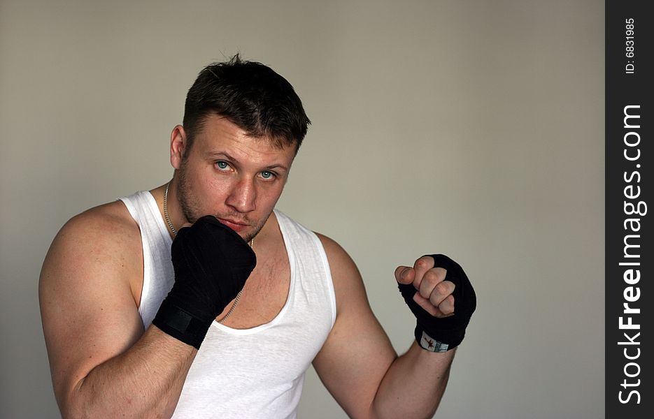 A young man with black fighting gloves and a bruise on the nose. A young man with black fighting gloves and a bruise on the nose