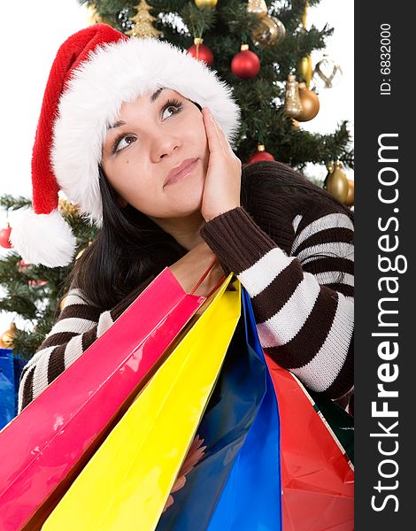 Attractive brunette woman happy over christmas tree. Attractive brunette woman happy over christmas tree