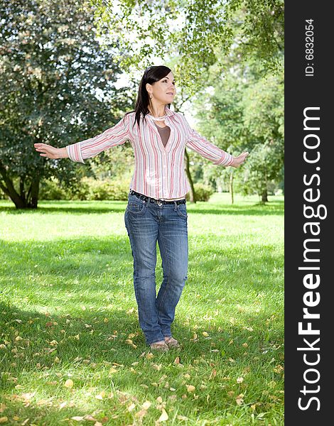 Casual woman relaxing in park. Casual woman relaxing in park