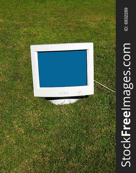 Computer monitor on the grass depicting outsourcing. Computer monitor on the grass depicting outsourcing