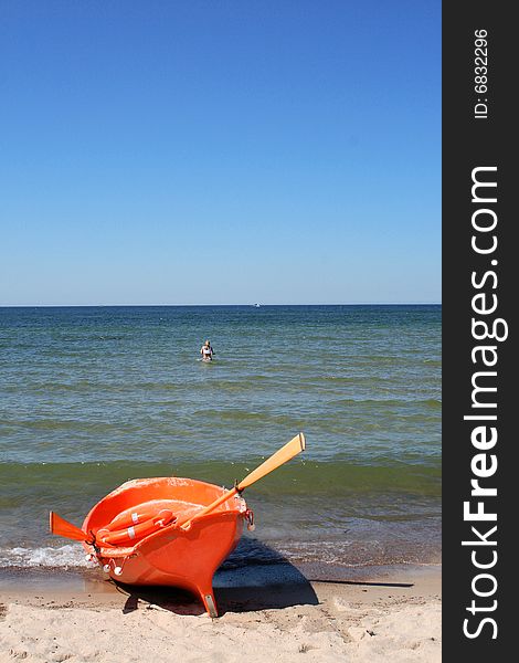 Orange boat on the shore of the Sea