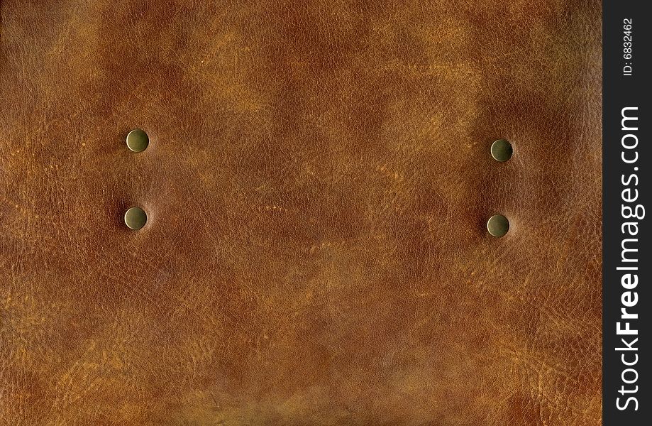 Close-up natural brown leather with rivet texture to background