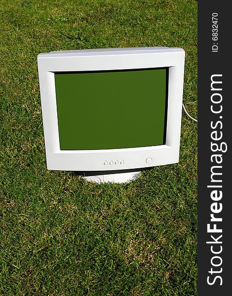 Computer monitor on the grass depicting outsourcing. Computer monitor on the grass depicting outsourcing