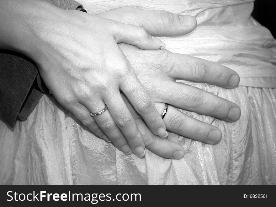 The groom holds the bride for a hand. The groom holds the bride for a hand